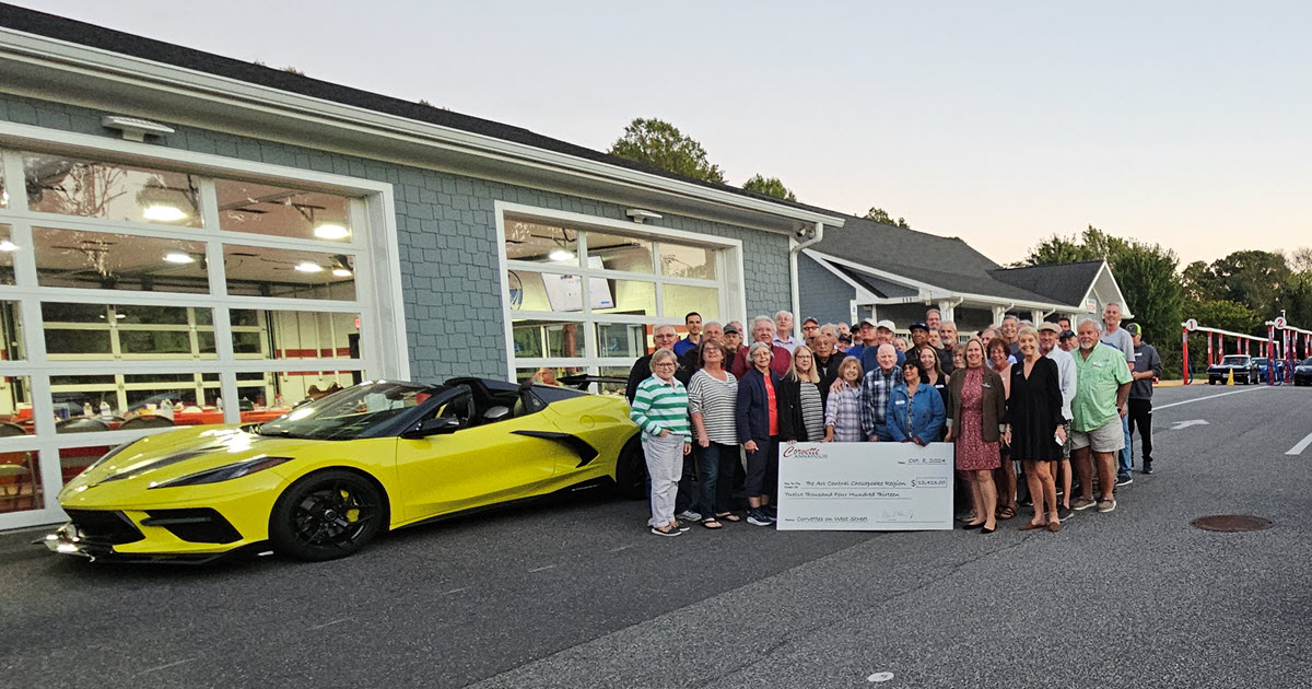 The Corvette Club of Annapolis presents a big check to The Arc