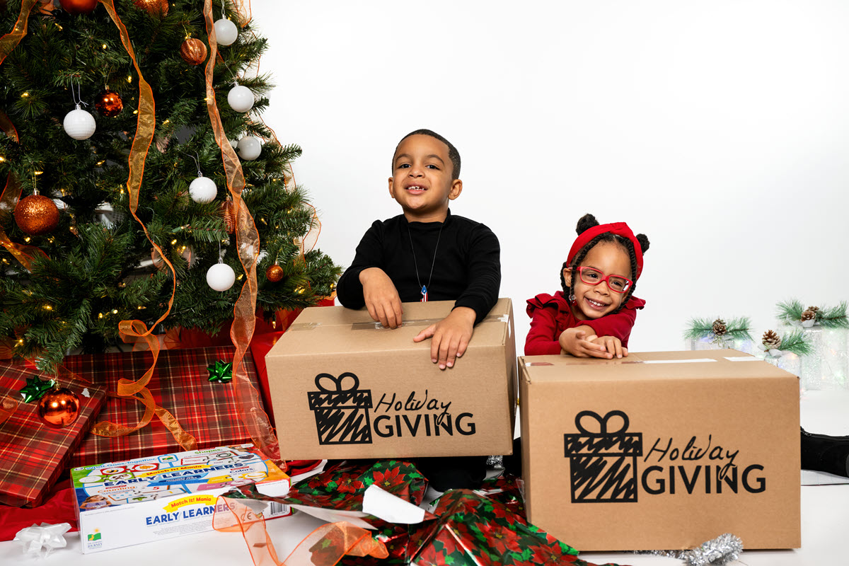 Two Children holding Holiday Giving Boxes