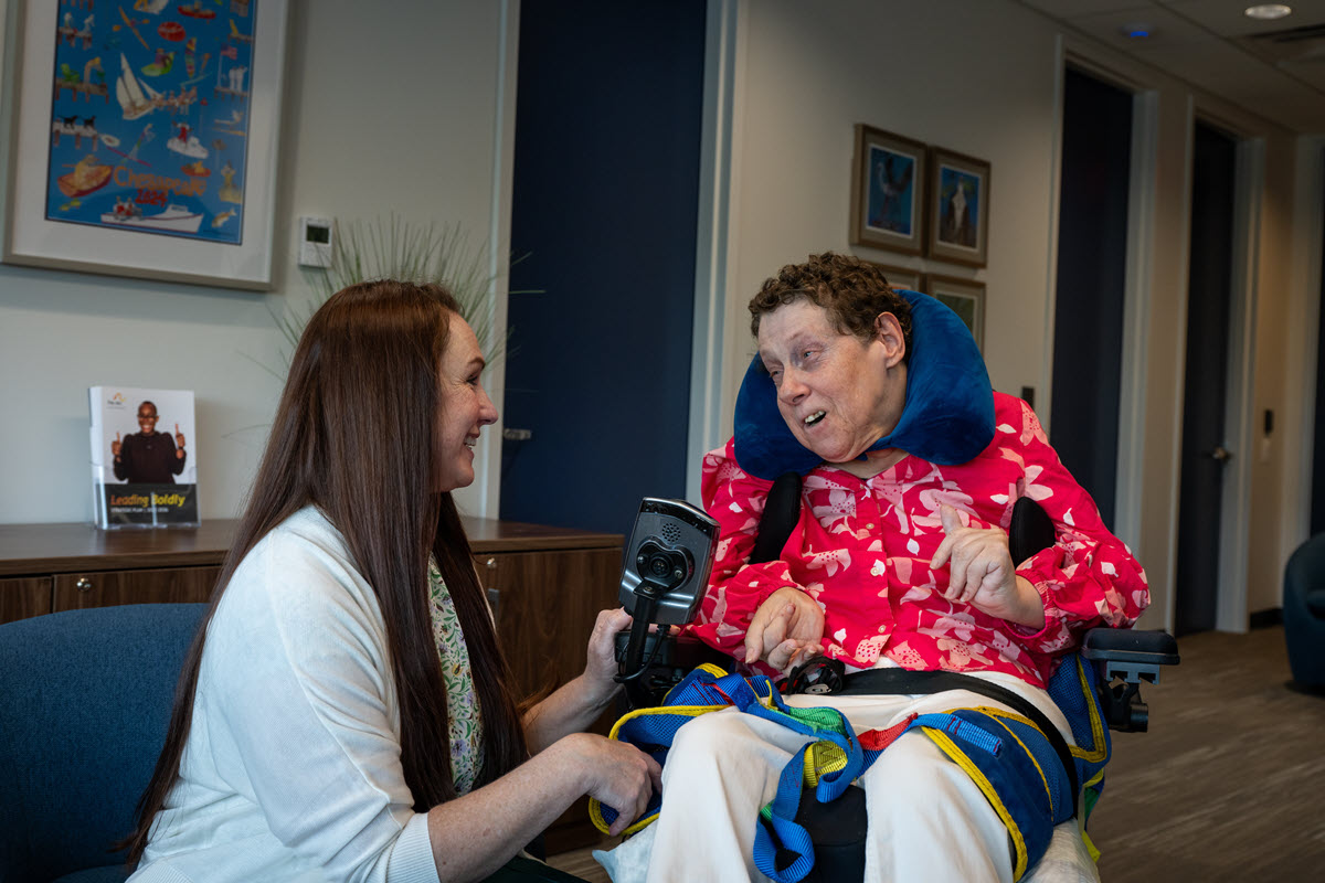 An Arc Behavioral Health clinician speaking with a person in a wheelchair
